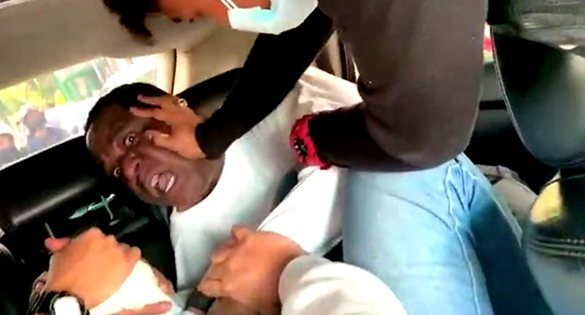 A screenshot taken on August 9 2021 shows the Nigerian diplomat being assaulted by immigration officials in Indonesia in a moving vehicle.