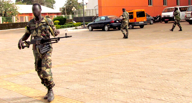 In this file photo taken on April 14 2012 Soldiers walk outside the National Assembly in Bissau. AFP 2