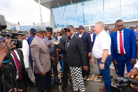 Rivers governor at the airport with crowd of persons