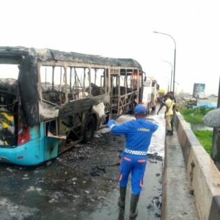 A burnt BRT bus at the scene of the accident
